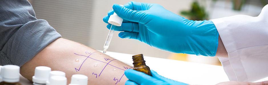 A physician administers an allergy test to a patient.