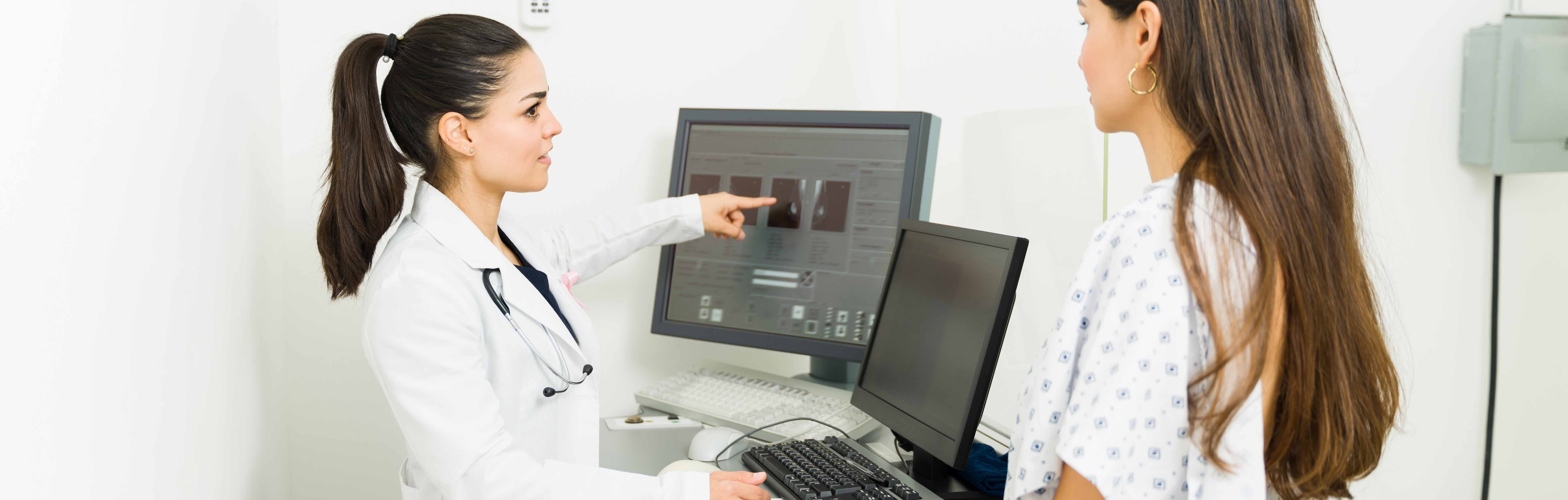 Physician showing patient the results of a mammogram.