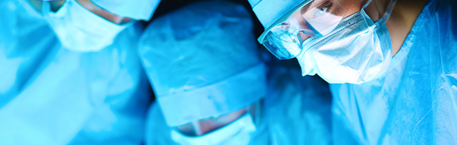 Close-up of surgeons' masked faces during a procedure