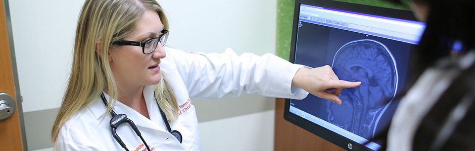 A Weill Cornel Medicine provider looks at a brain scan.