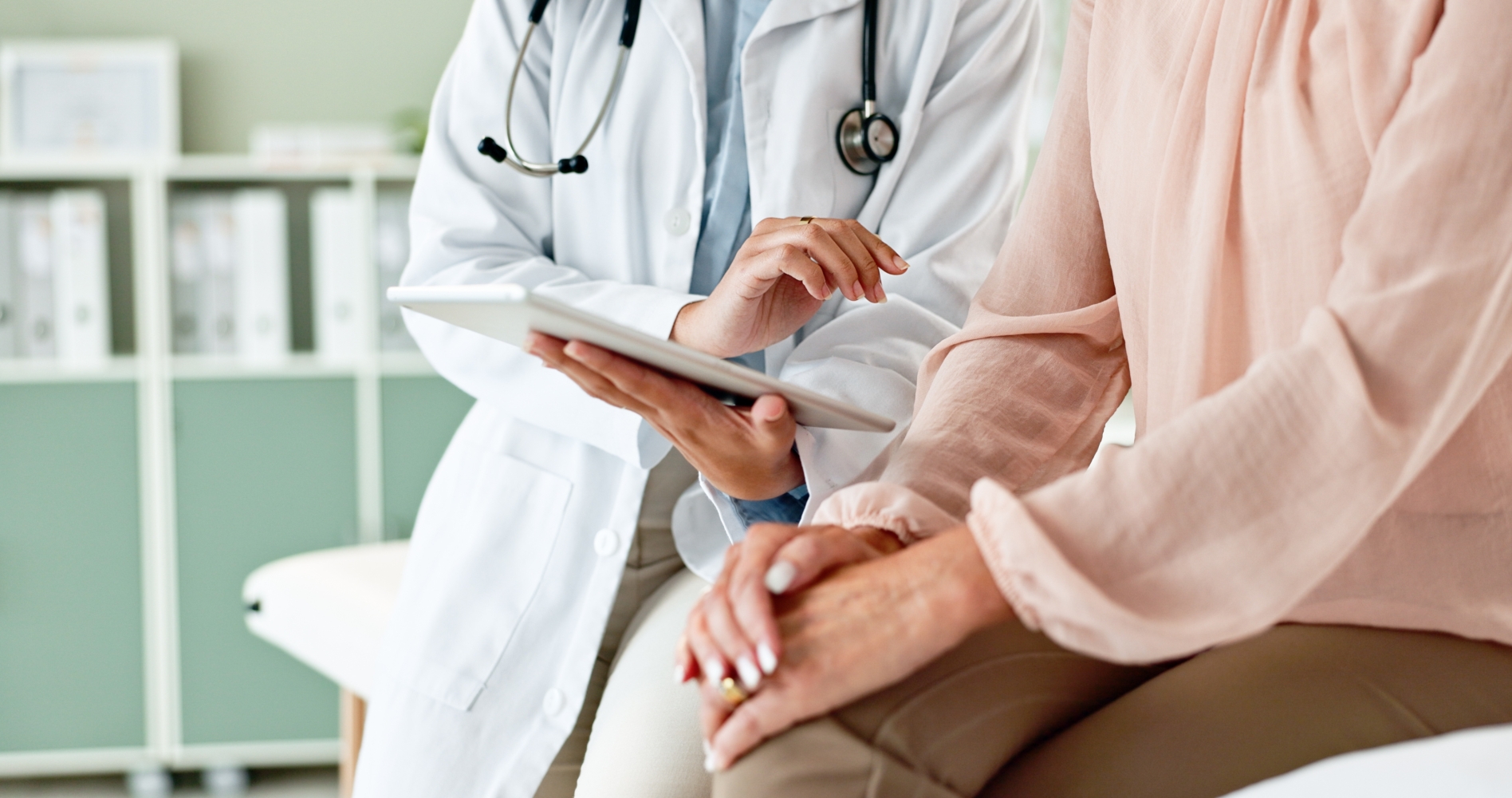 Doctor and patient looking at tablet together