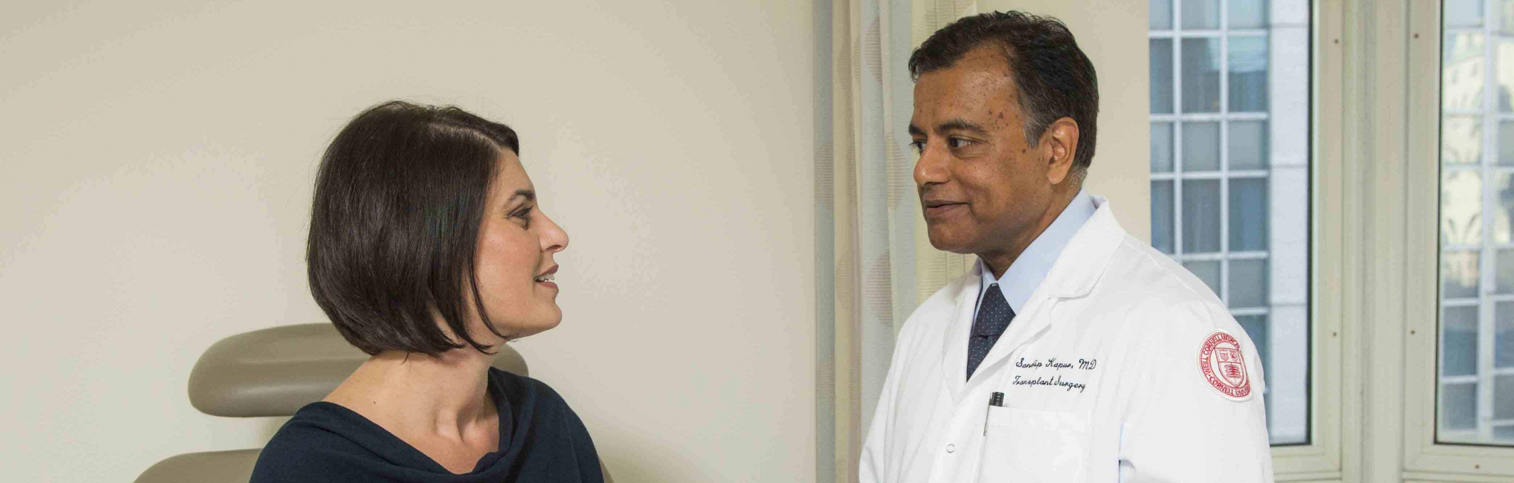 Dr. Sandip Kapur interacts with a patient.