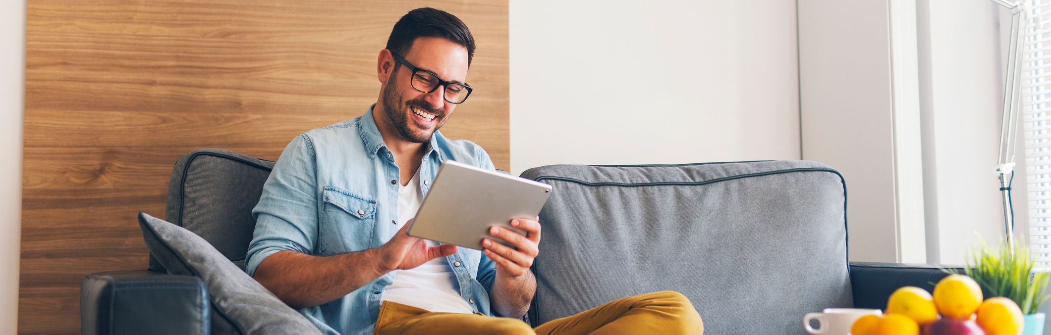 Man using tablet on the couch.