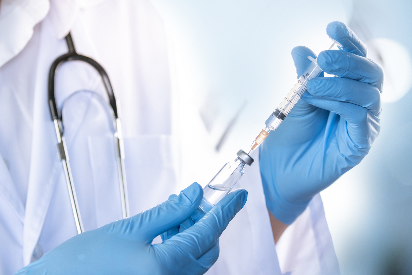 Doctor with injection in his/her hands
