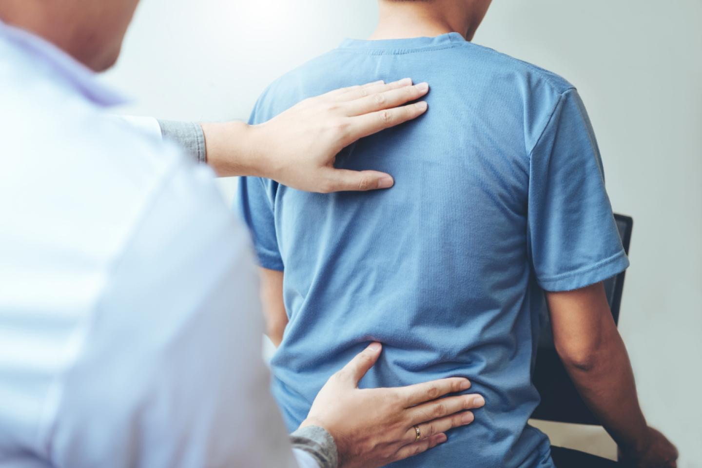Doctor checking patients's back