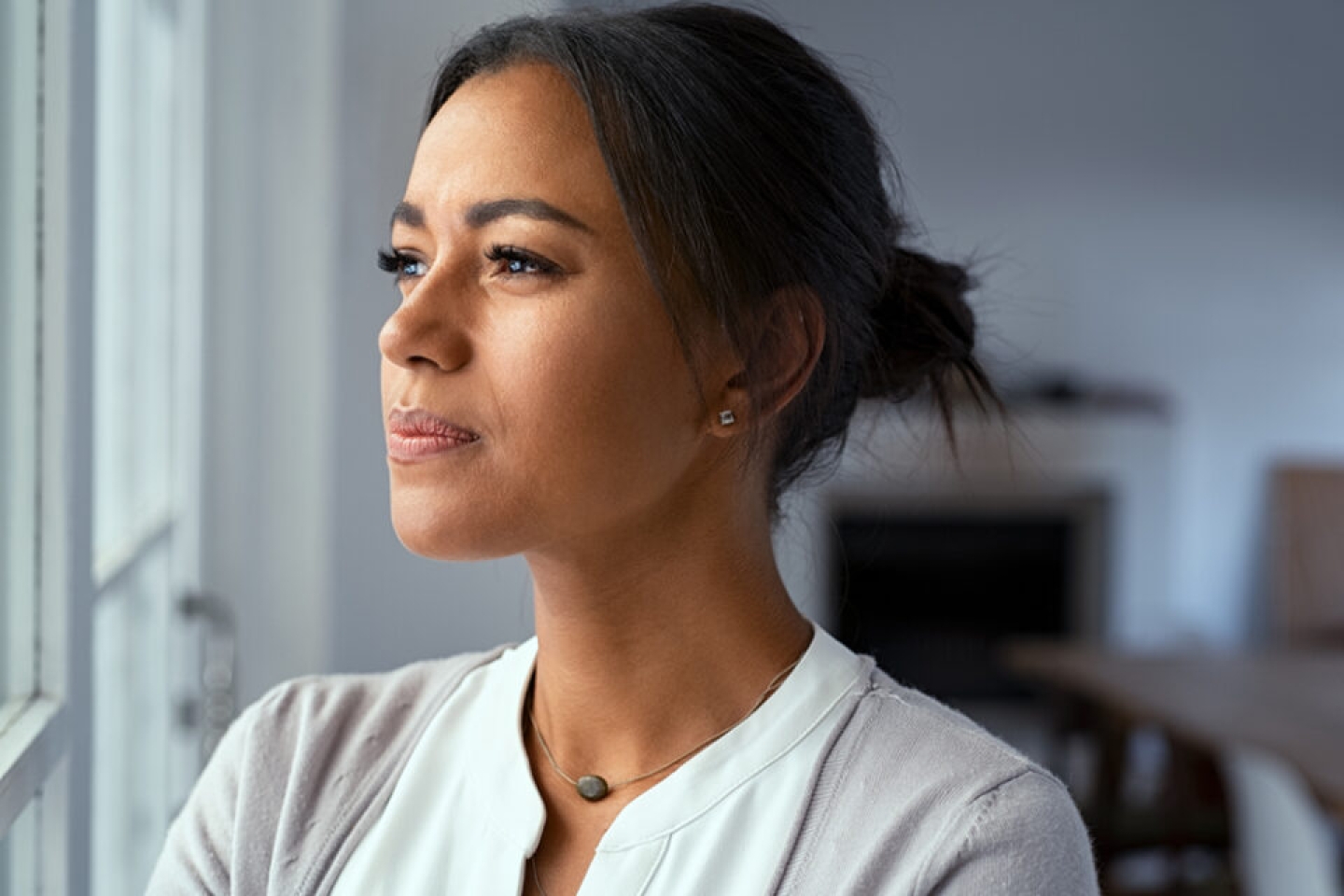 woman looking pensive out of window