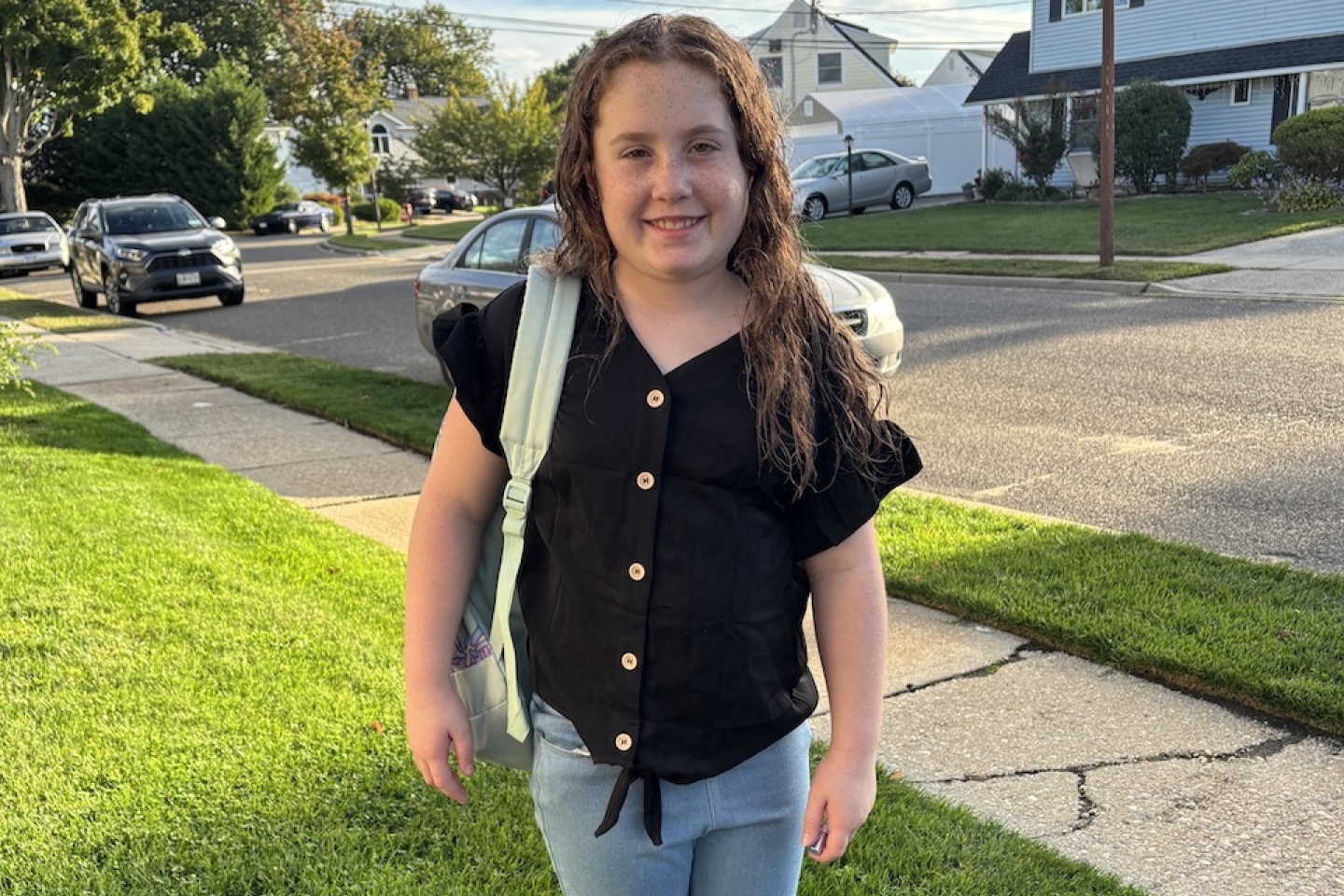 Emma standing with backpack
