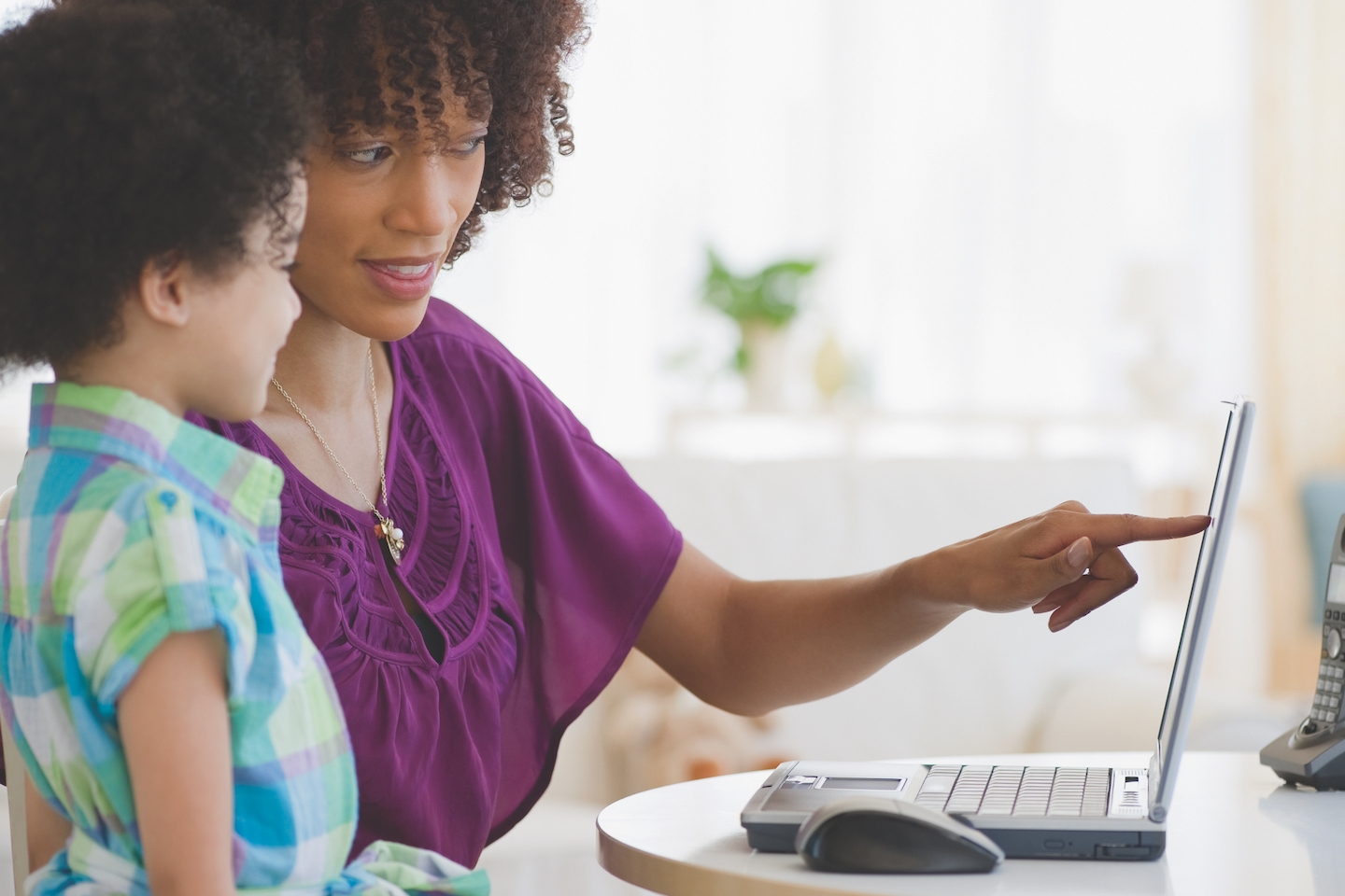 Mom and child looking at a laptop