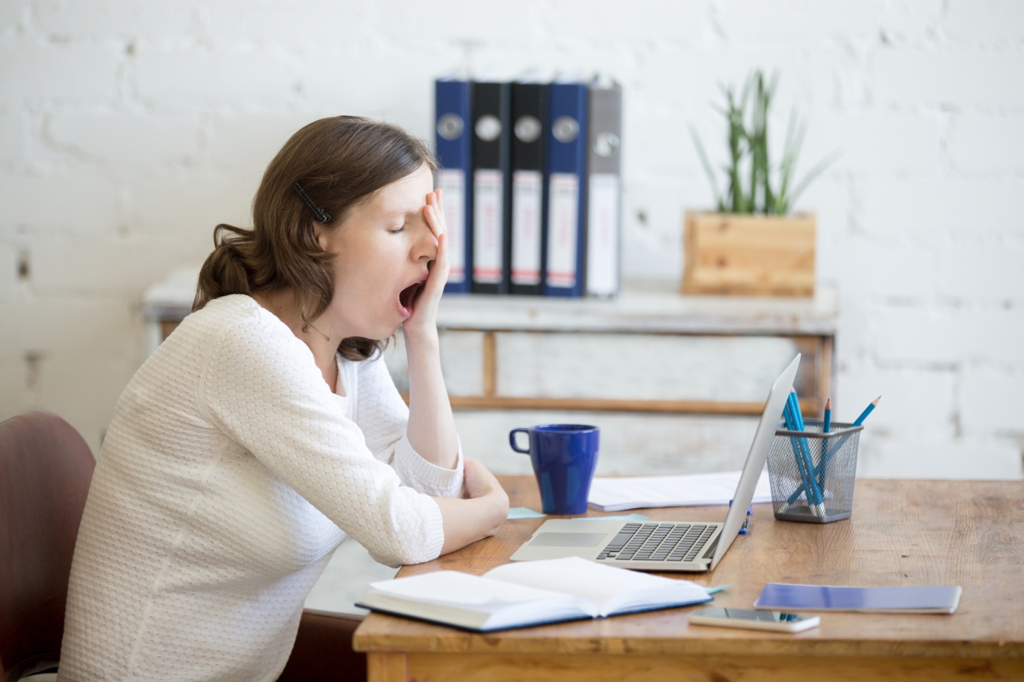 Woman yawning at desk