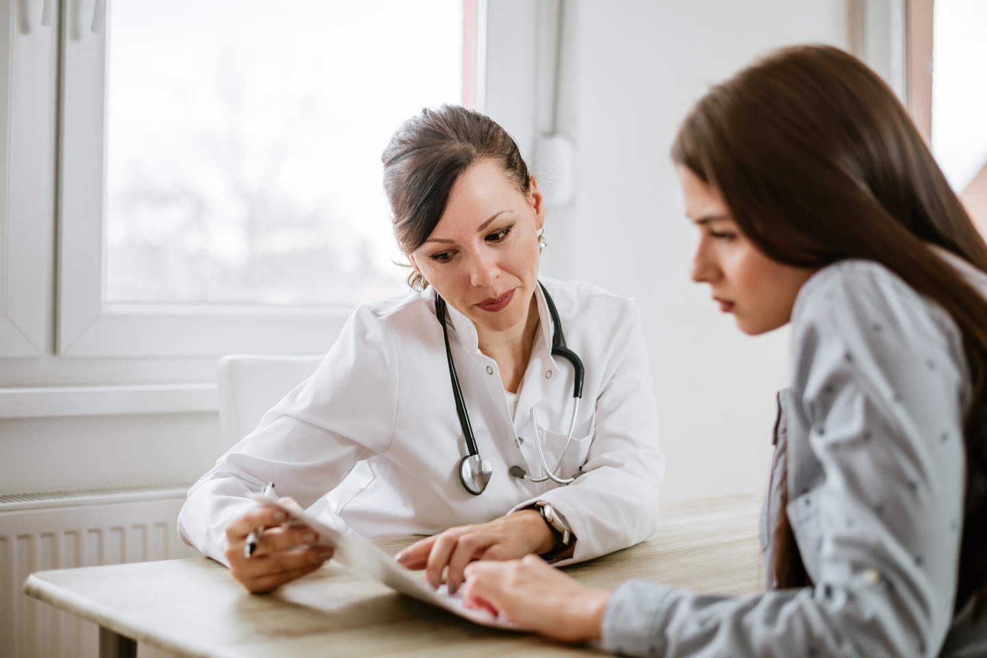 Doctor and patient looking over document together