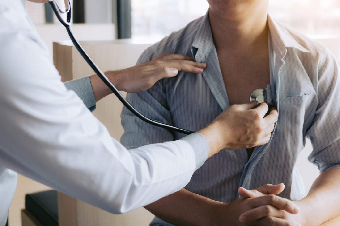 Doctor checking patient's heart