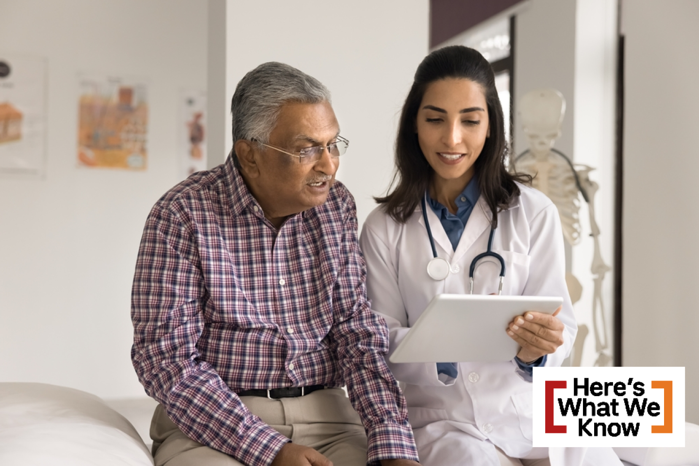 Positive young Indian doctor woman showing electronic content on tablet computer to senior Indian man, speaking to patient, explaining healthcare examination results
