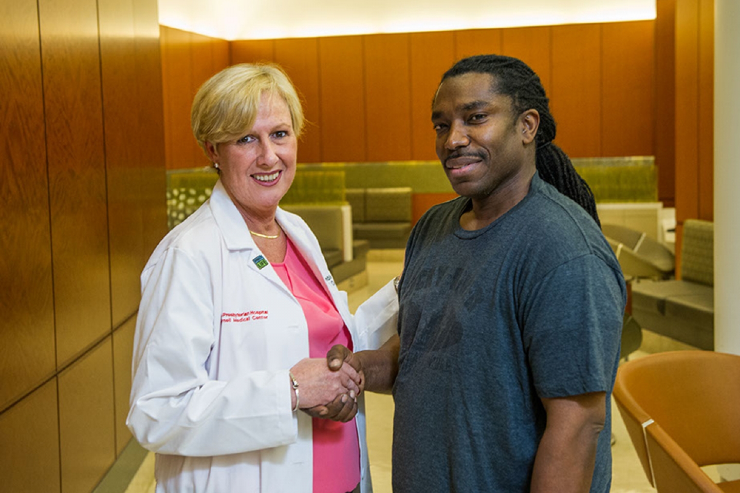 Patient and doctor pose for a photo