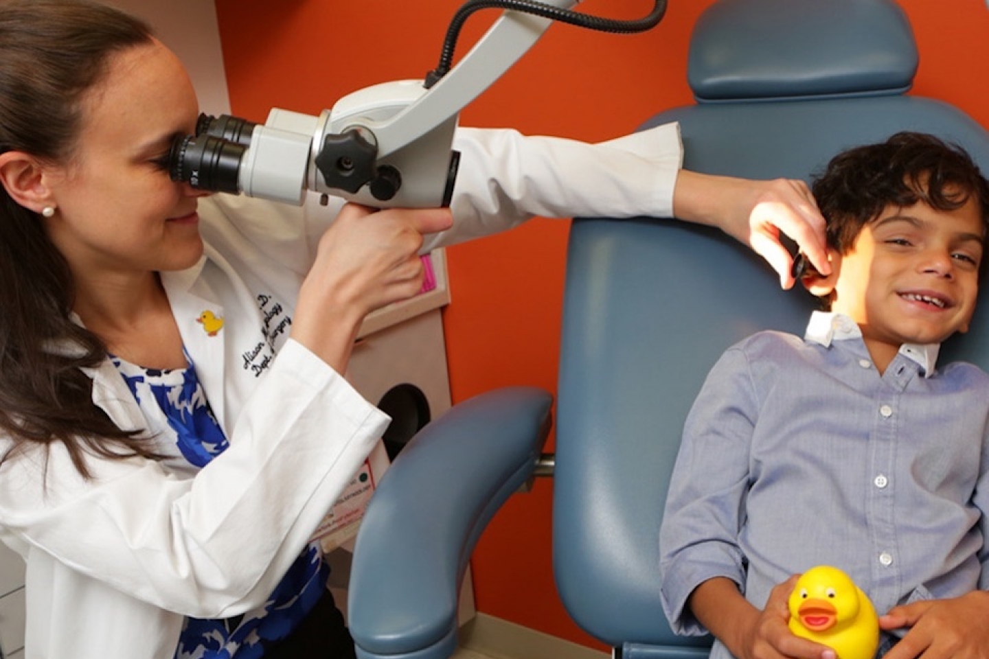 dr maresh conducts ear exam on child patient