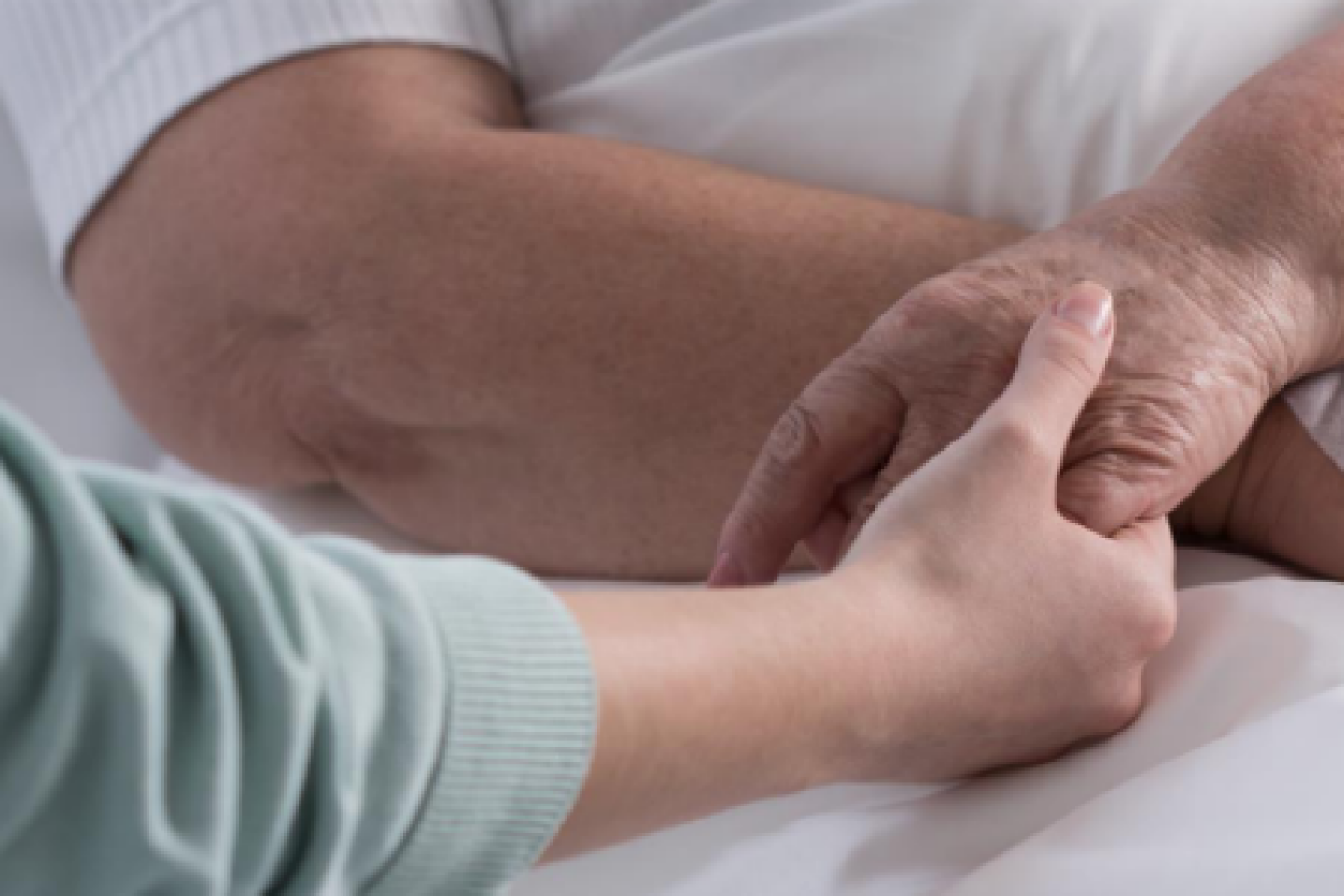 Someone holds a patient's hand