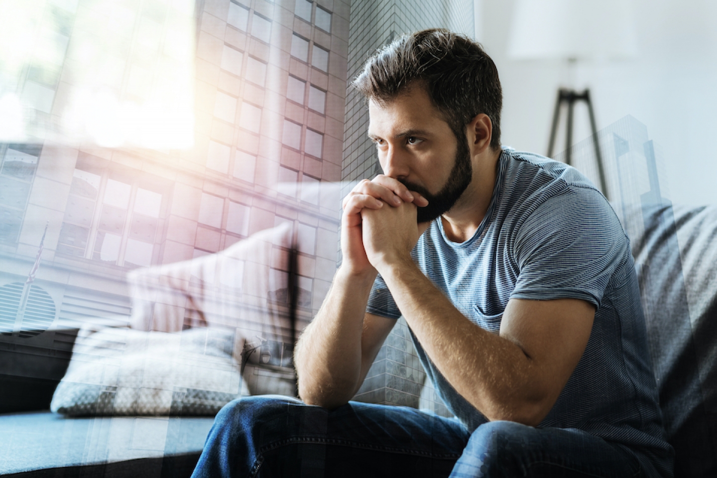 man contemplating at home