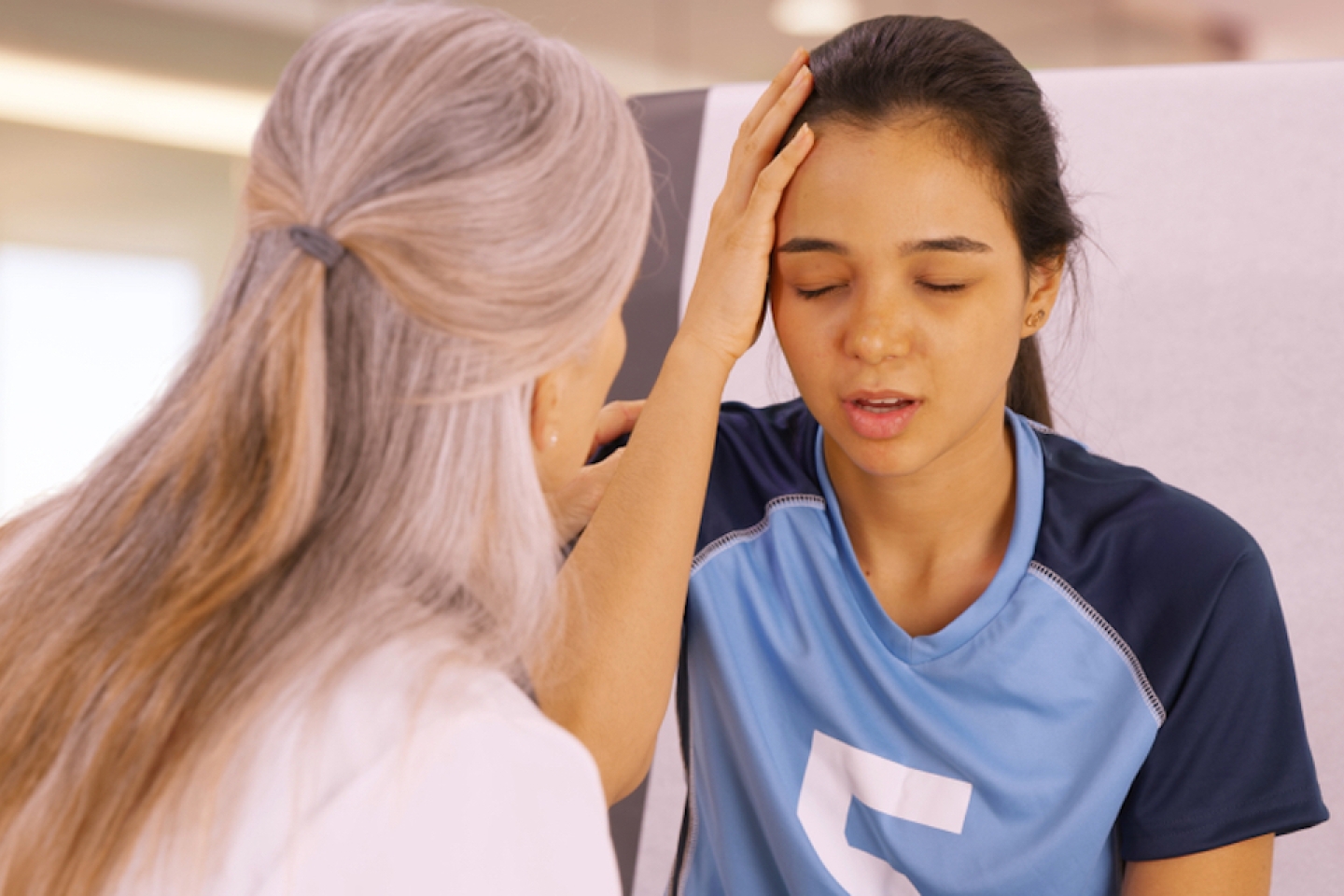 A concussed soccer player seeks help at the doctors office