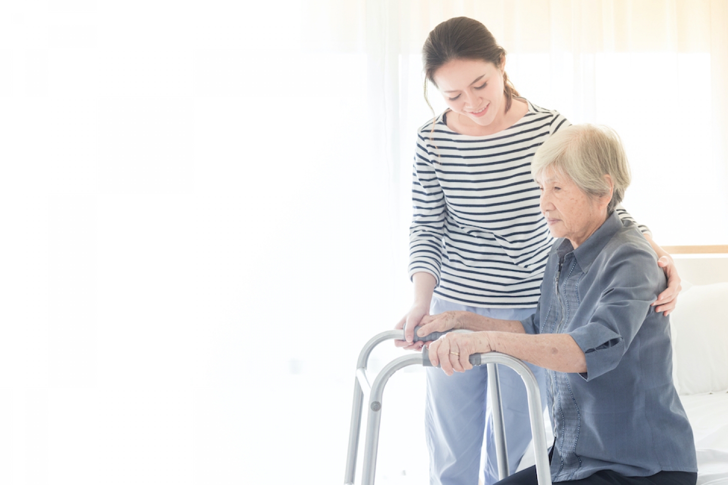 younger woman assisting older woman