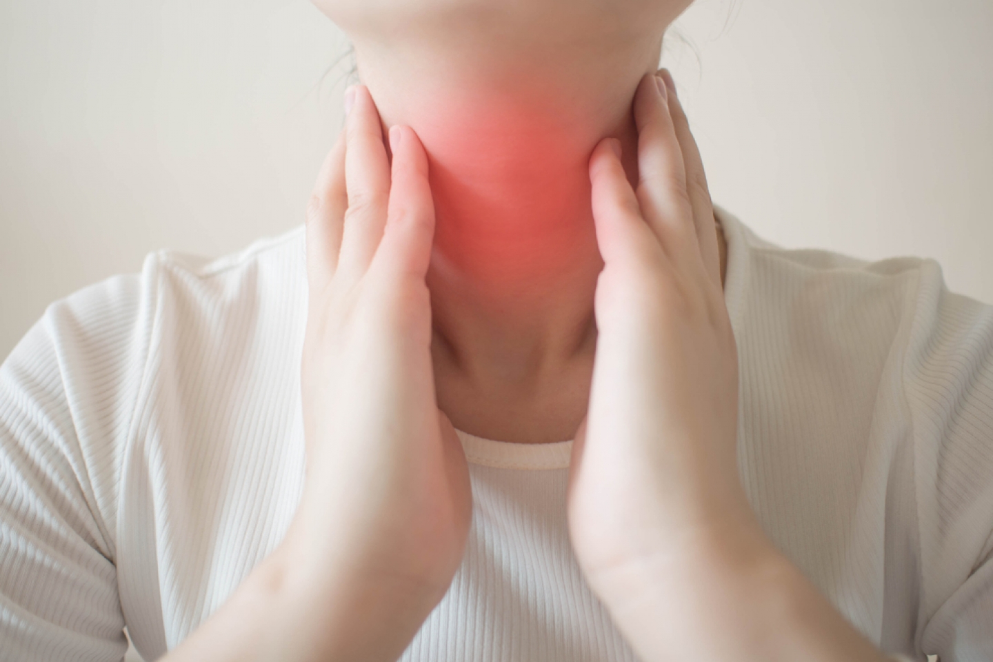 Female checking thyroid gland by herself. 