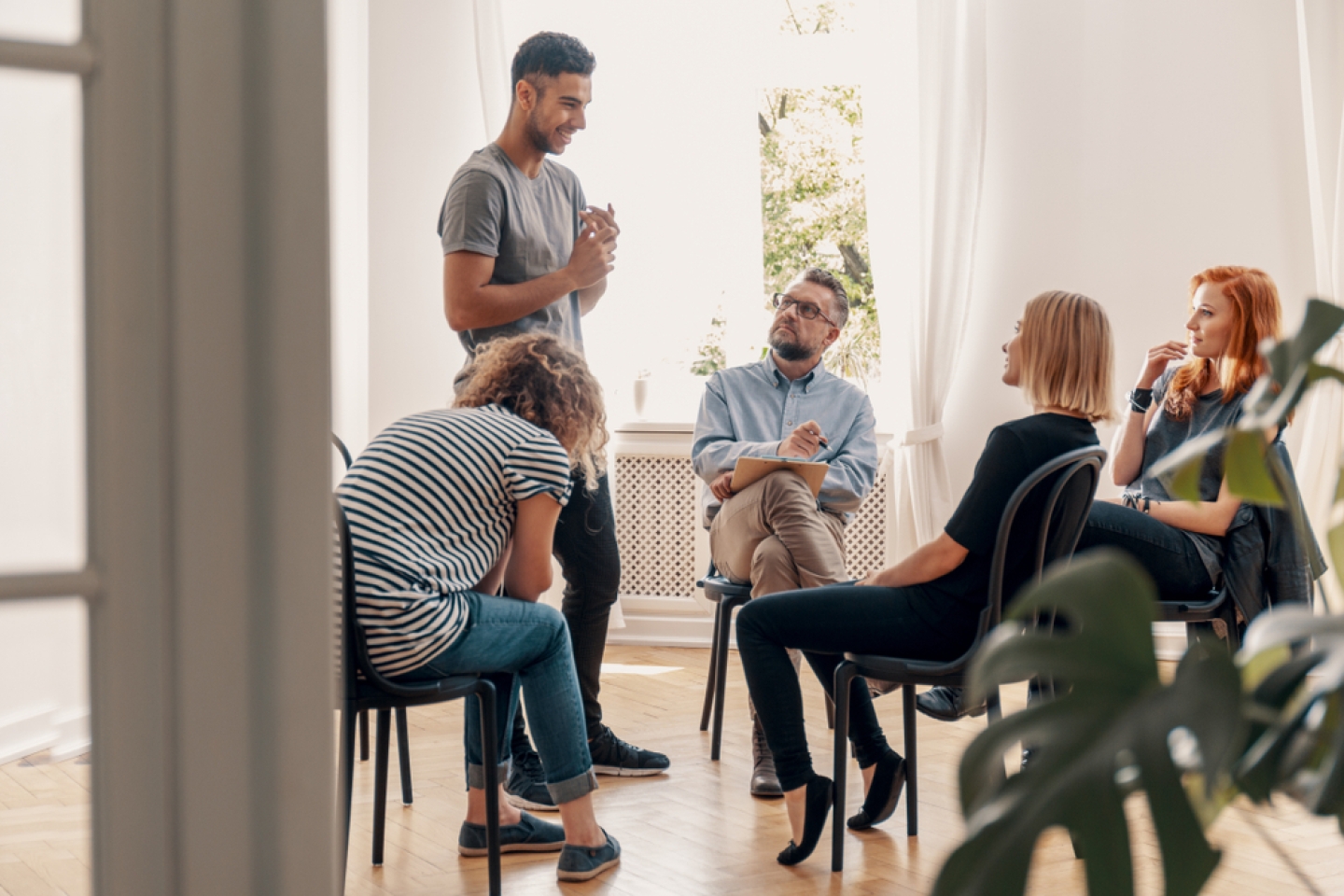 Man talking to his support group about his successful fight with drug addiction