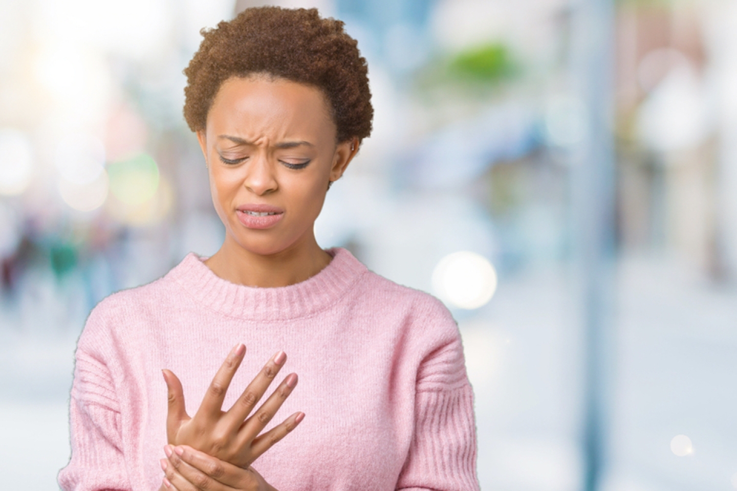 woman over isolated background Suffering pain on hands and fingers,