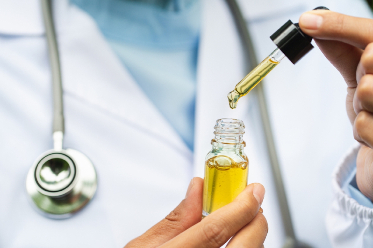 Doctor holding a bottle of hemp oil,