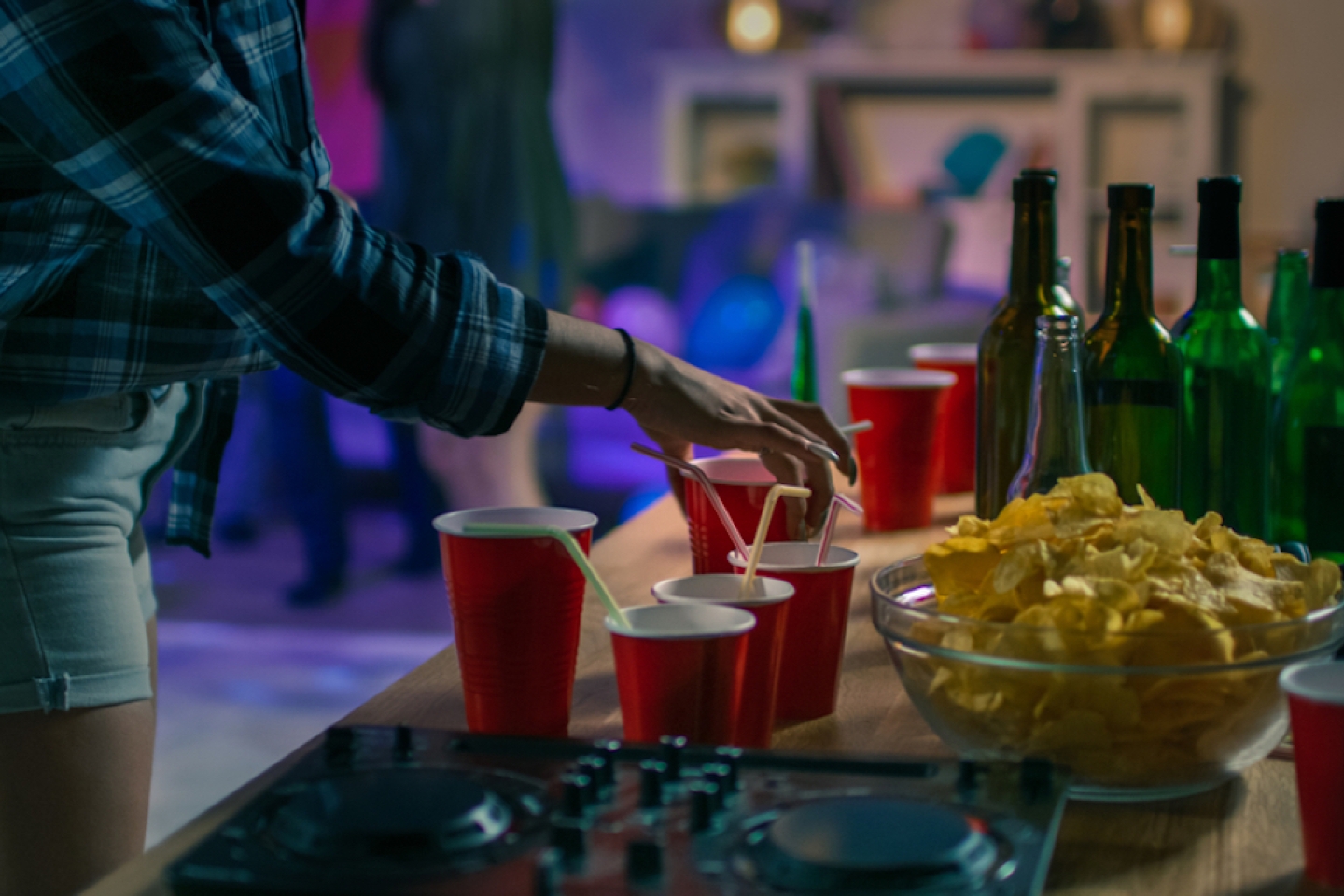 At the College House Party: Girl Takes Glass with Drink from the Tray