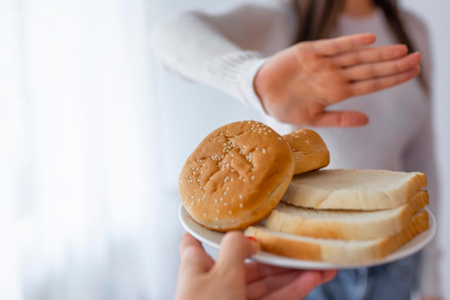 Young woman on gluten free diet is saying no thanks to toast