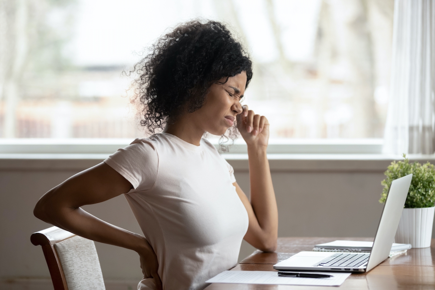 woman at desk with backache