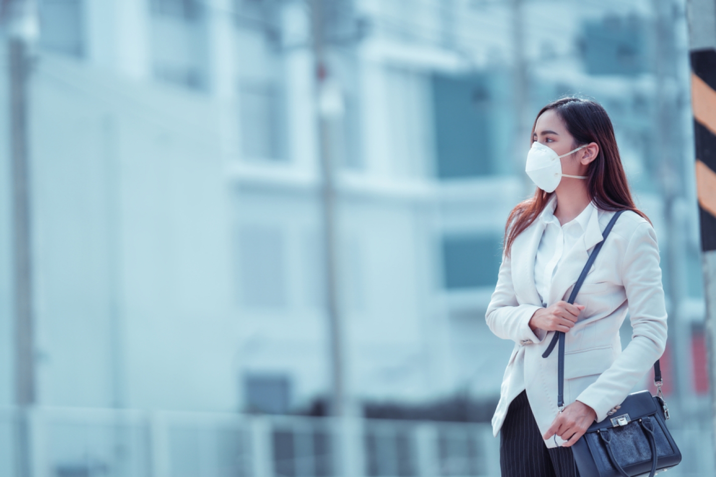 Asian woman are going to work.she wears N95 mask.prevent PM2.5 dust and smog