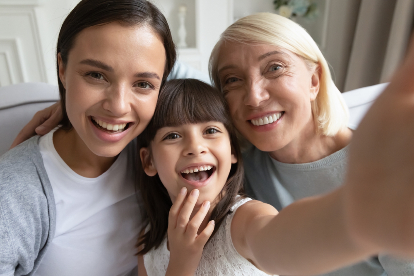 Webcam close up view cheerful faces of little granddaughter her mother and grandmother