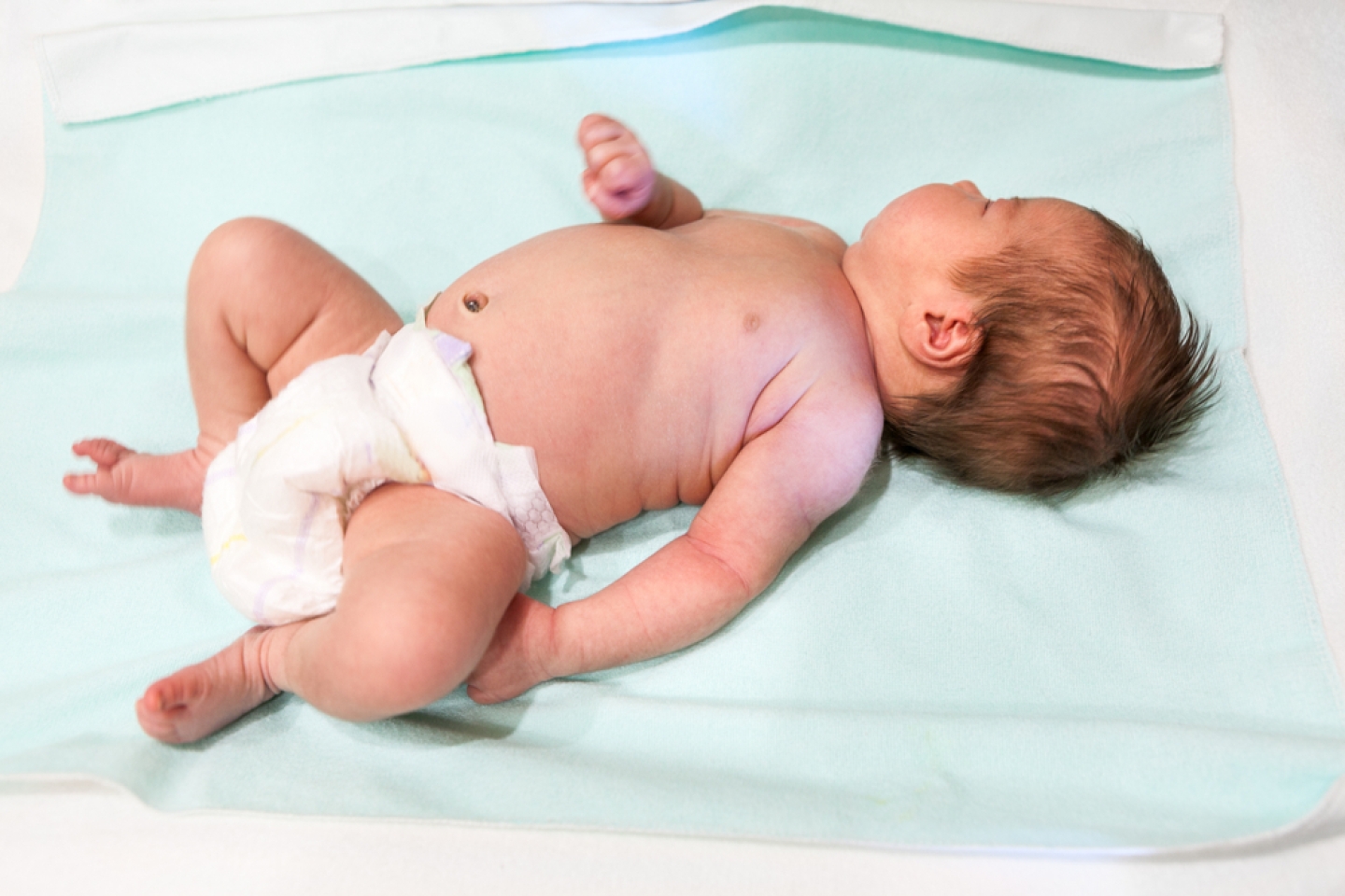 Newborn lying on back asleep