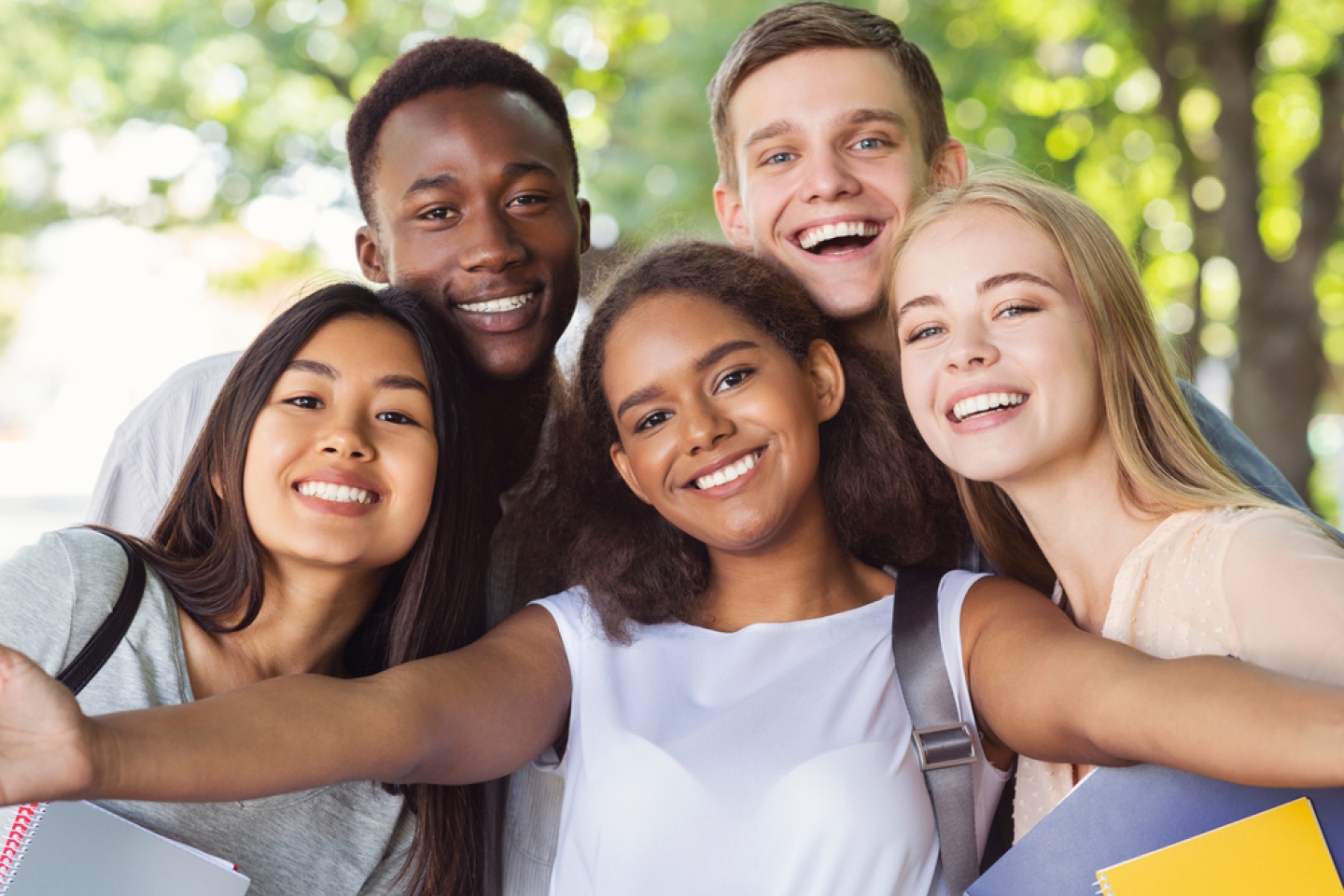 teenagers taking selfie while walking in summer park