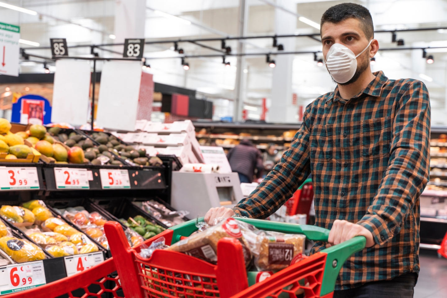 man wearing face mask while grocery shopping