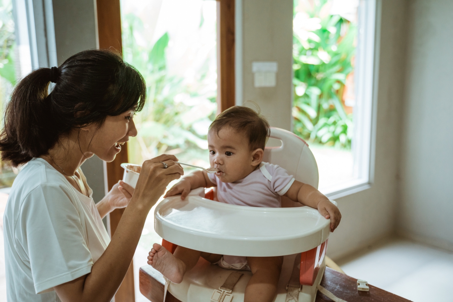 woman feed her baby at home