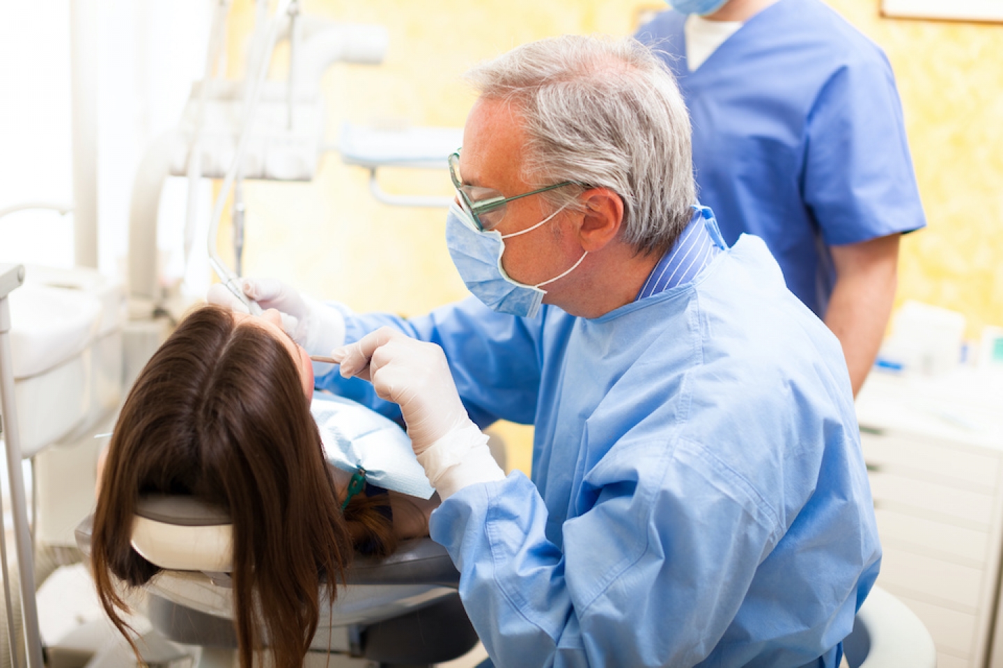 dentist checking patient's teeth