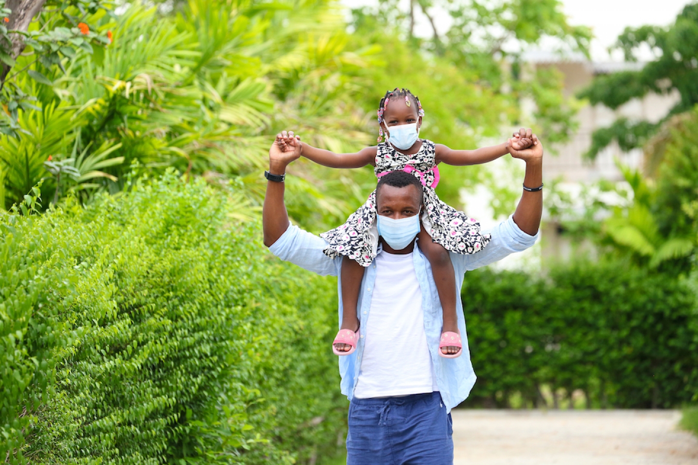 black dad and daughter outside