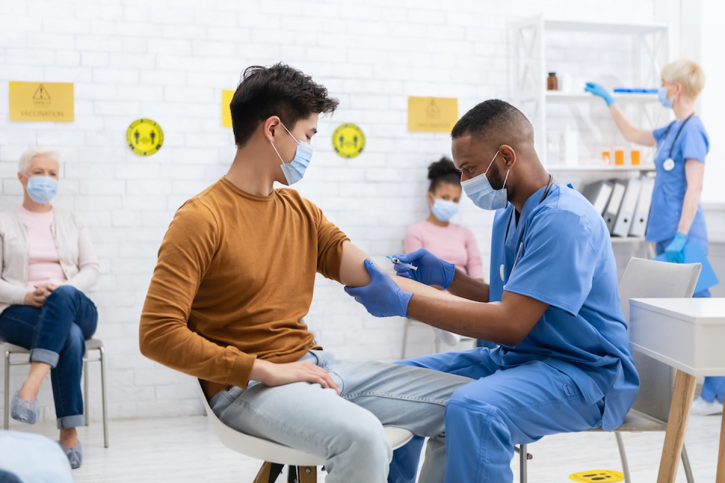 patient receiving vaccine from doctor