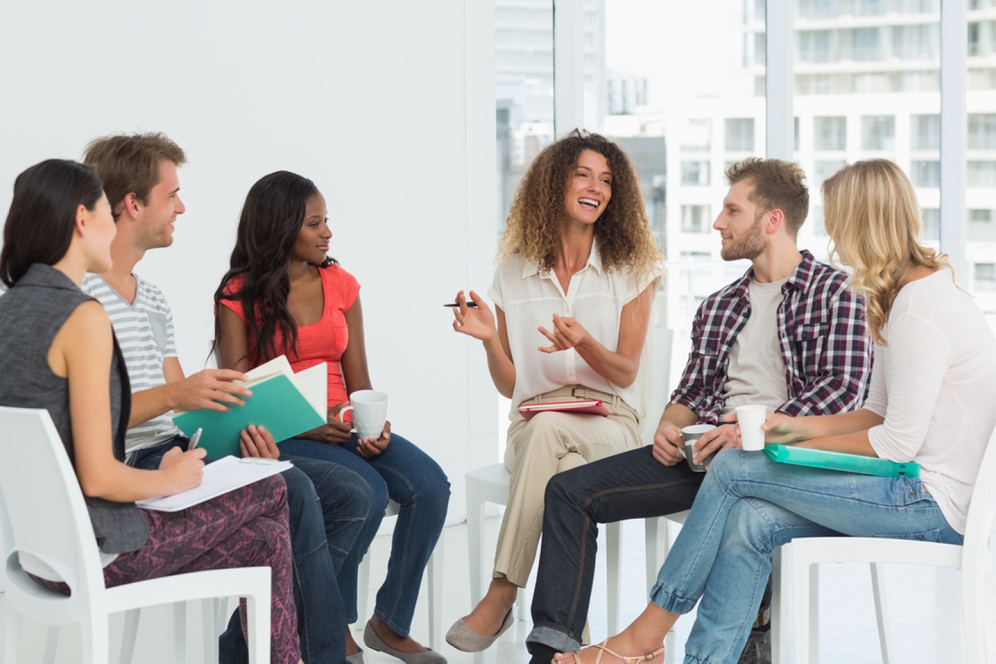 Smiling therapist speaking to a rehab group at therapy session