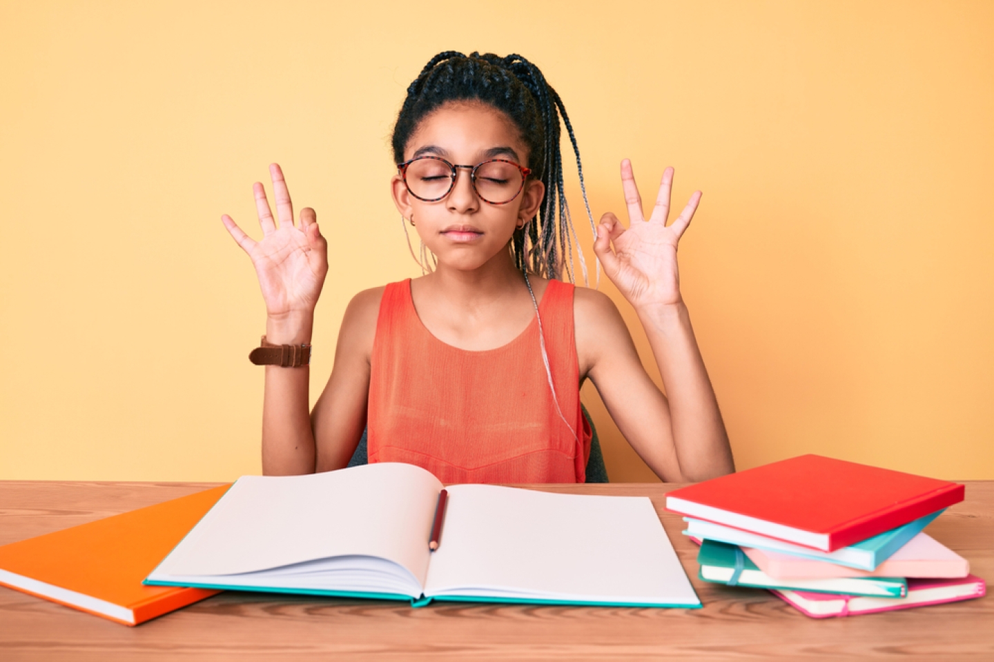 Young african american girl child with braids studying for school exam relax and smiling with eyes closed doing meditation gesture with fingers