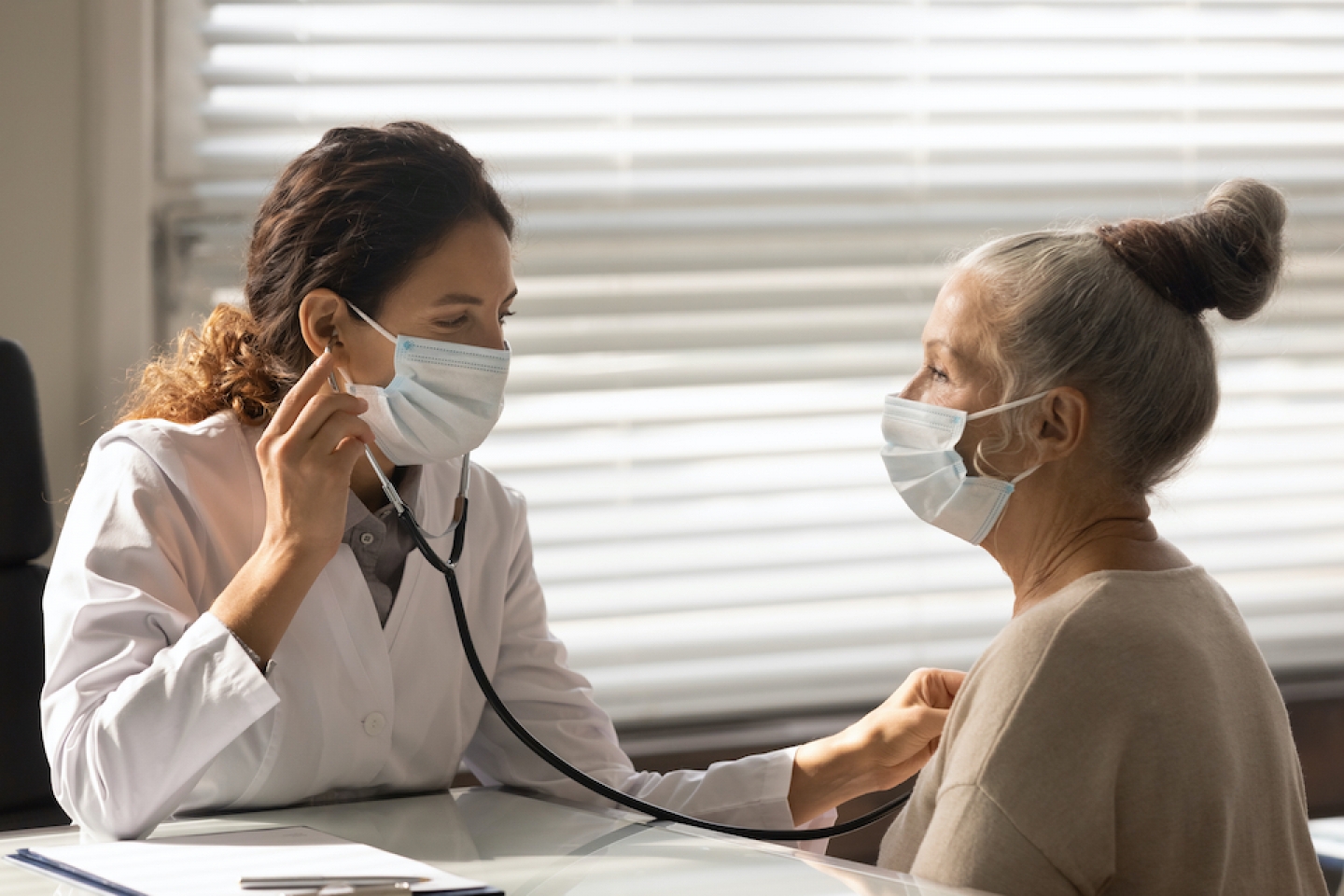 doctor checking patient's heart