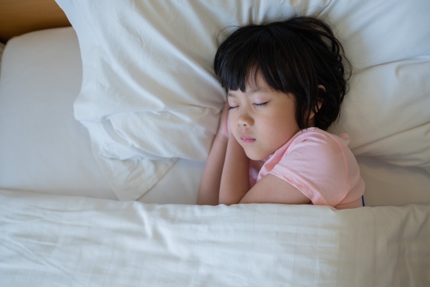 asian kid sleep on bed