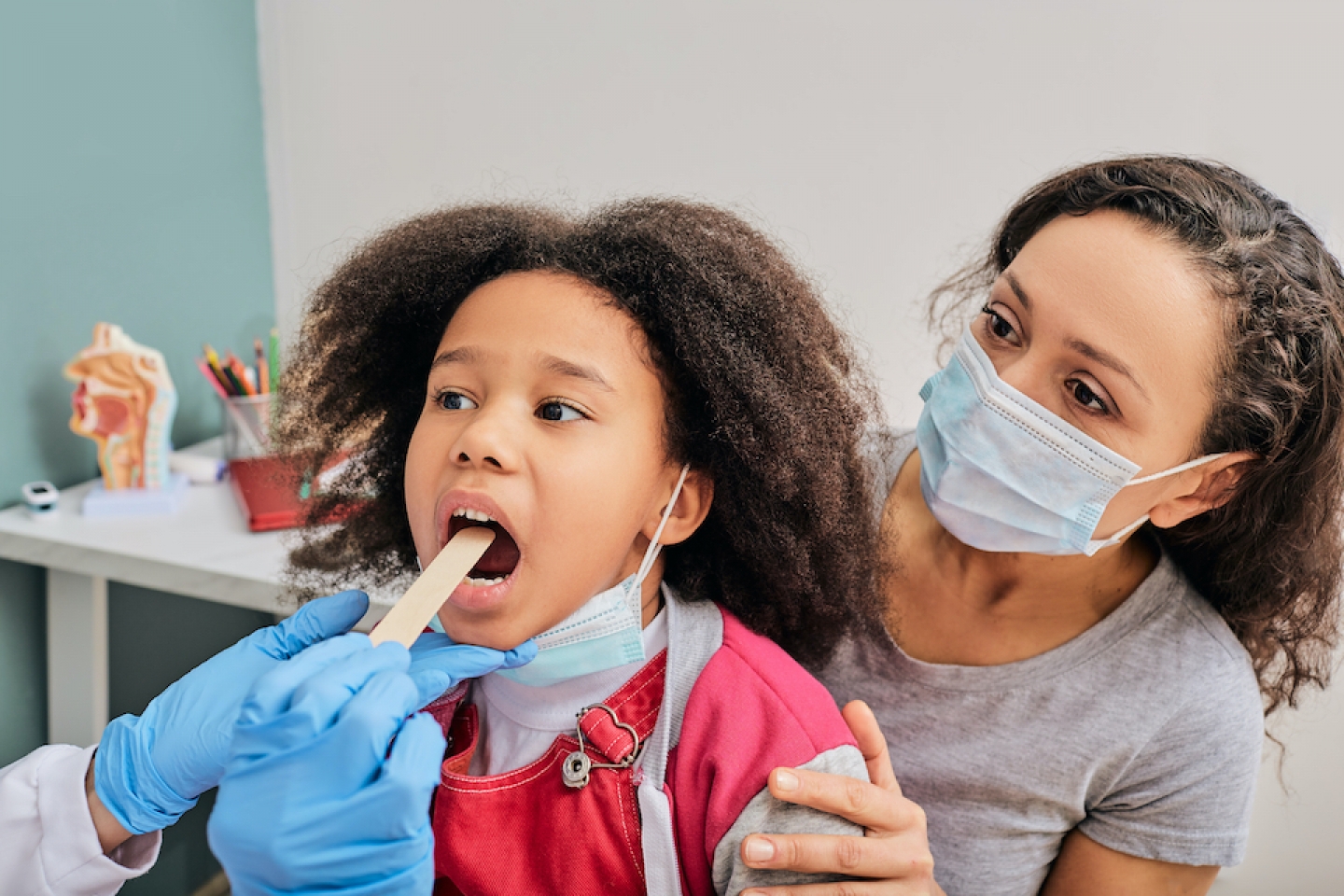 doctor check up with young girl patient