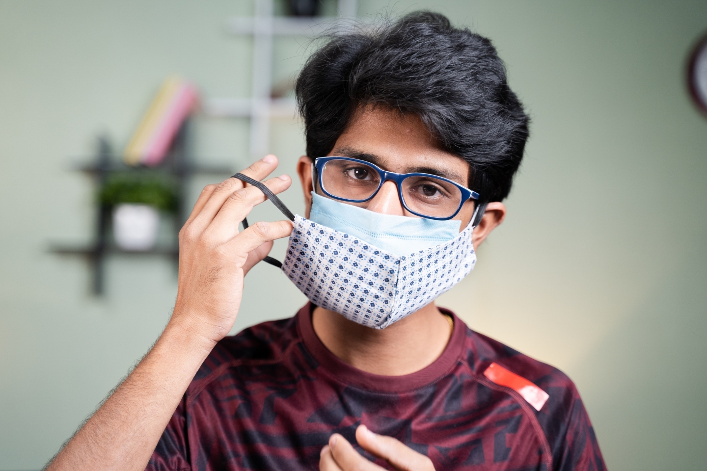 Young man wearing double face masks to protect from COVID-19 outbreak.