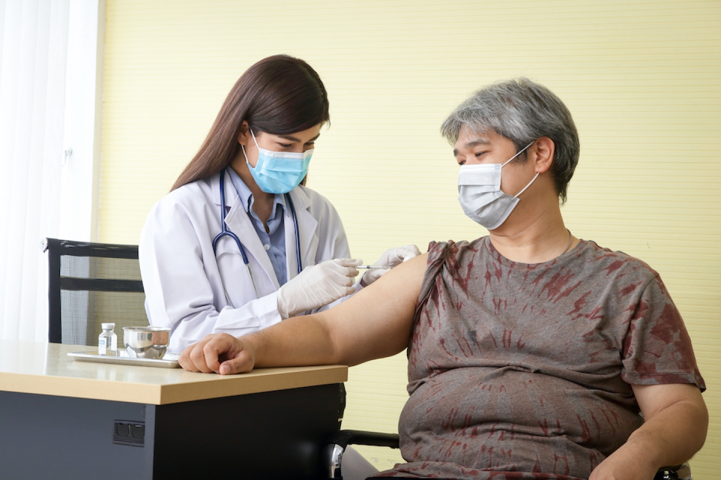 doctor administers vaccine to patient with obesity