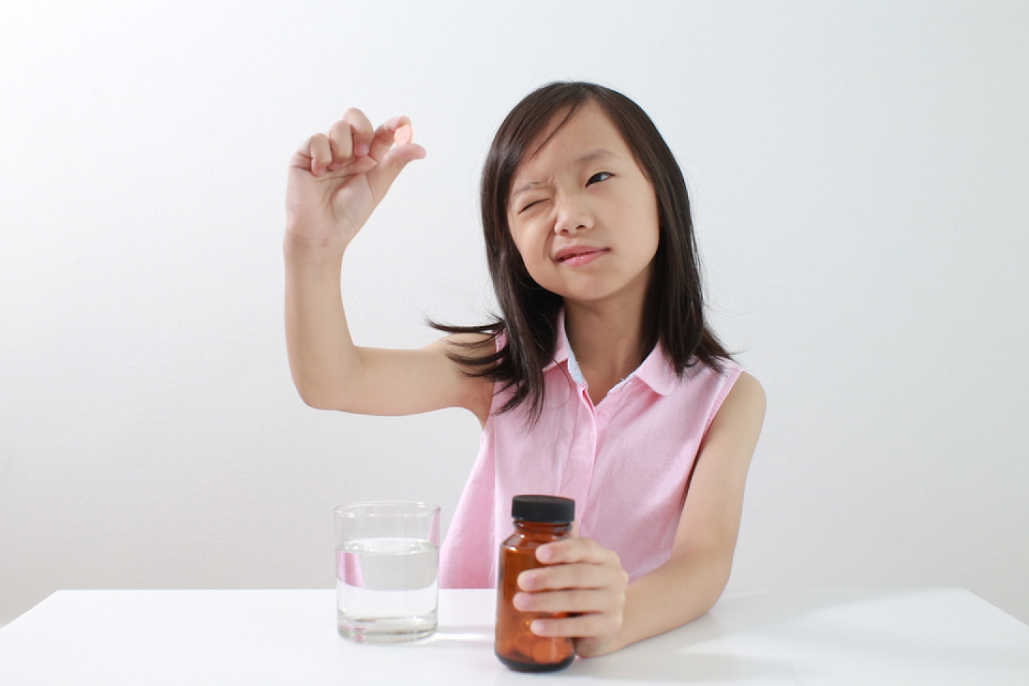 young girl with a vitamin in her hand