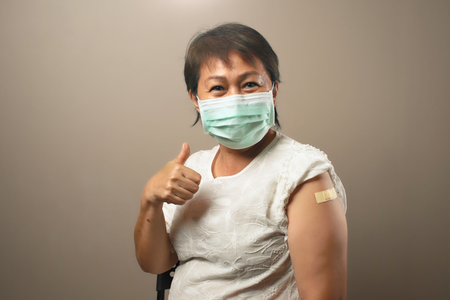 older woman after receiving her booster shot