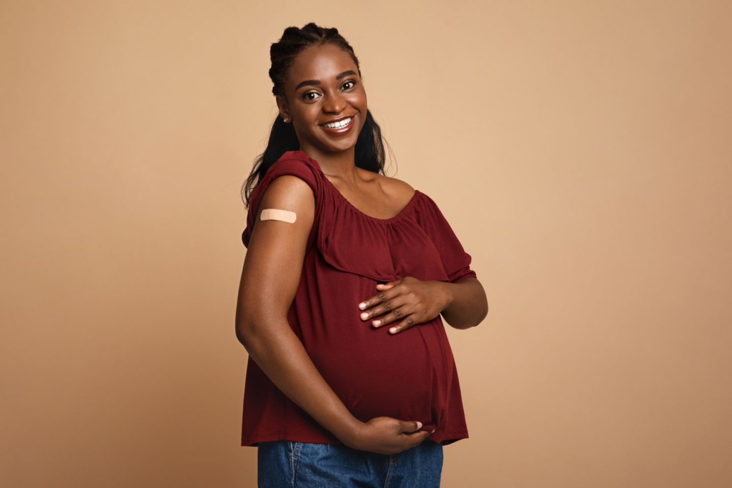 Safety vaccination during pregnancy concept. Cheerful pregnant young black woman got vaccinated.