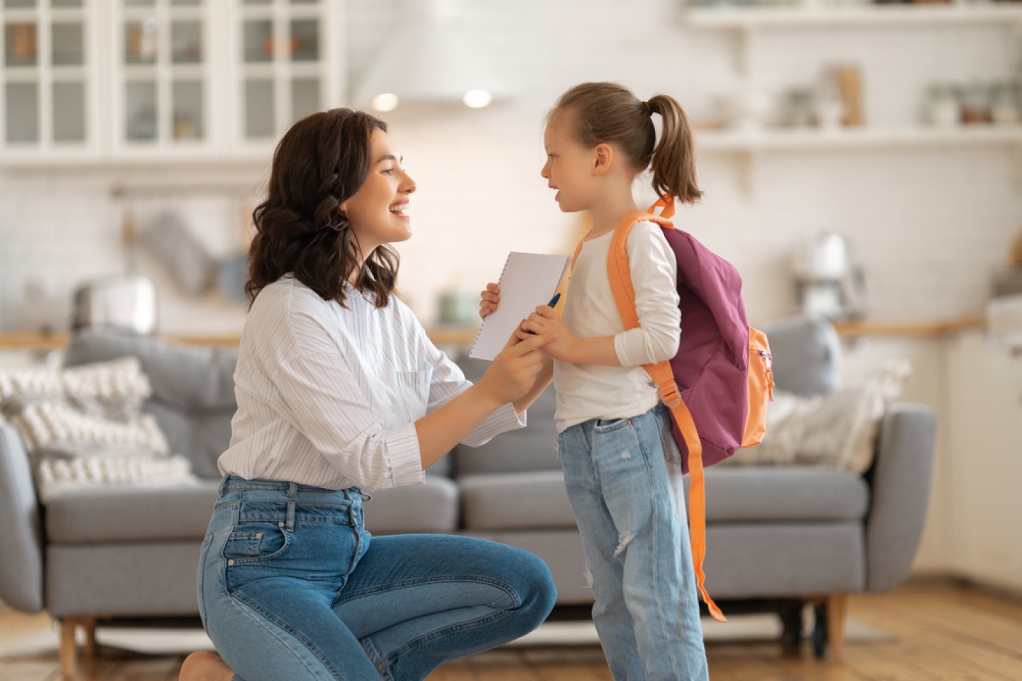 Happy family preparing for school. Little girl with mother.