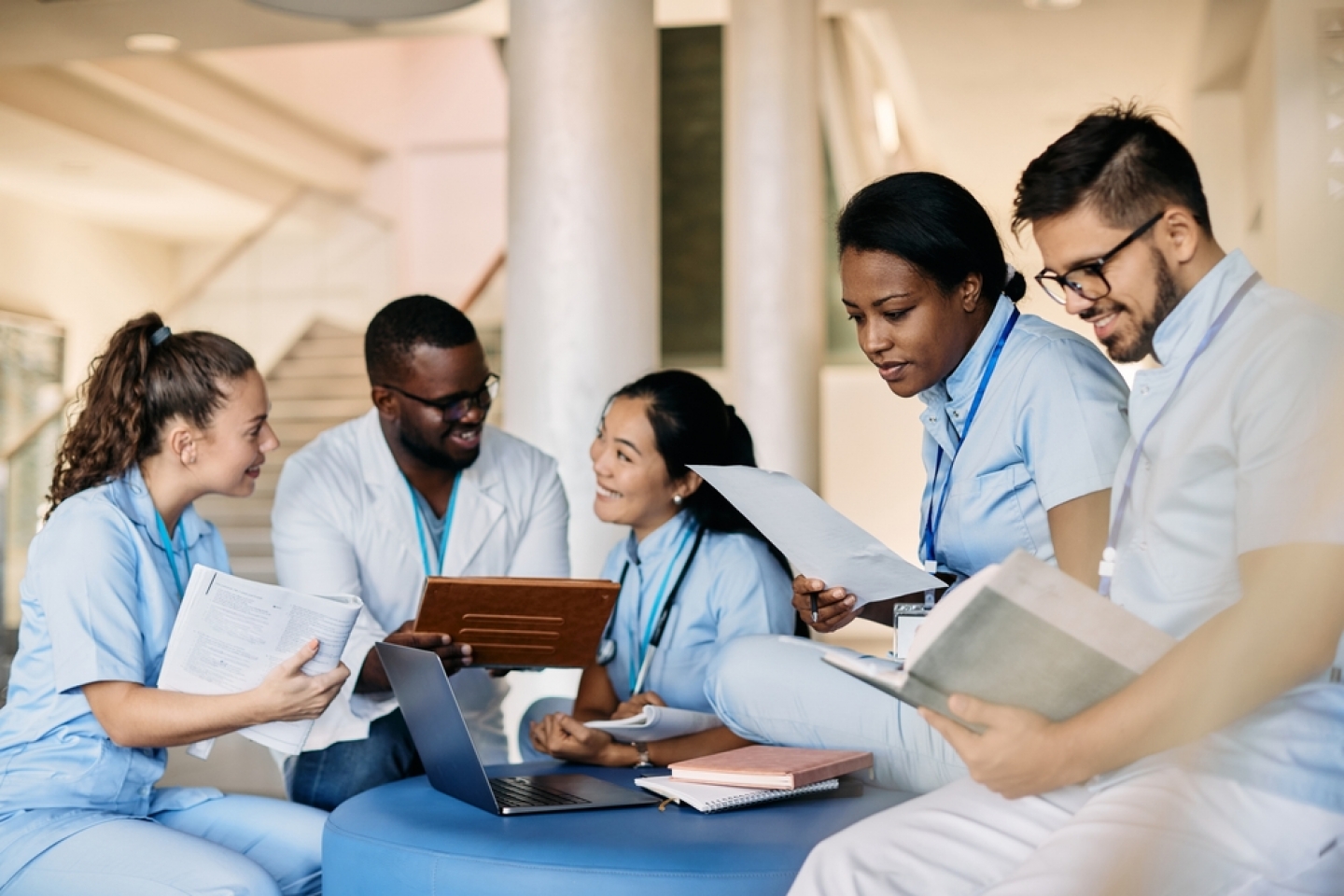 Group of multiracial students preparing for exam and learning together at medical university. Focus is on African American female student.